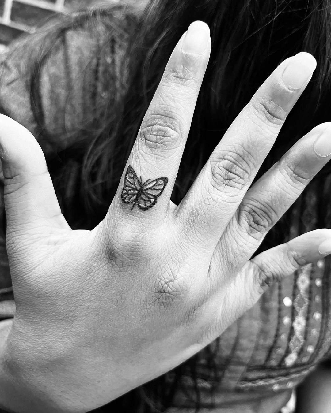 A-black-and-white-butterfly-finger-tatto