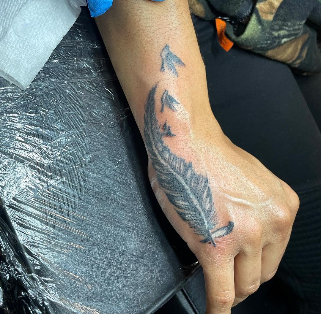 18 Elite Feather On Hand Tattoos: Handy Symbols Of Freedom