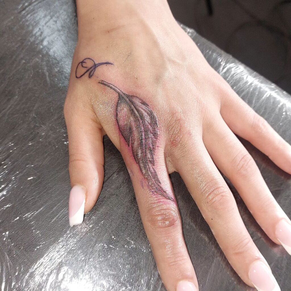 11 Epic Feather On Finger Tattoo Ideas To Wear Like A Ring